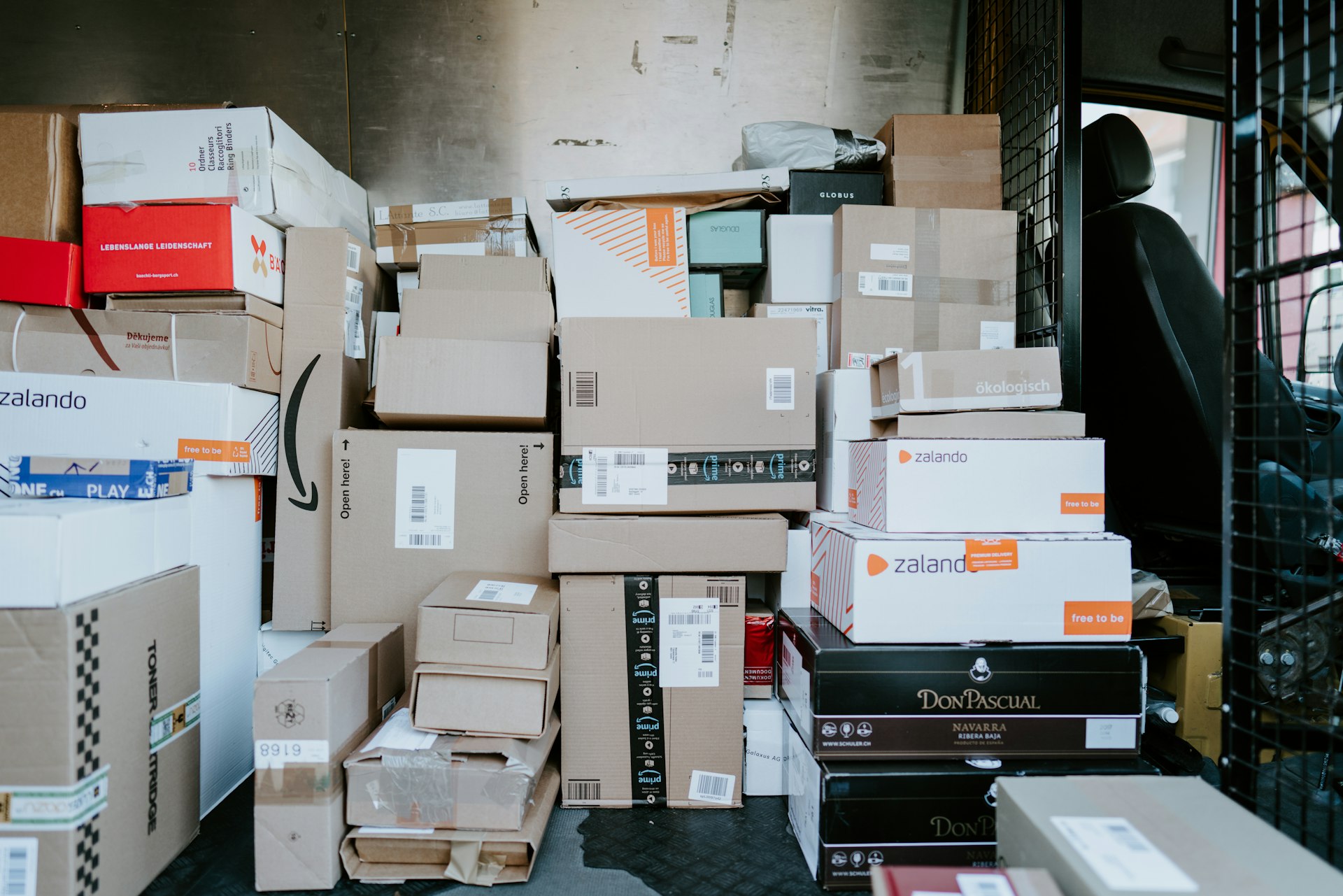 Stacked delivery parcel boxes packed and ready inside a distribution vehicle