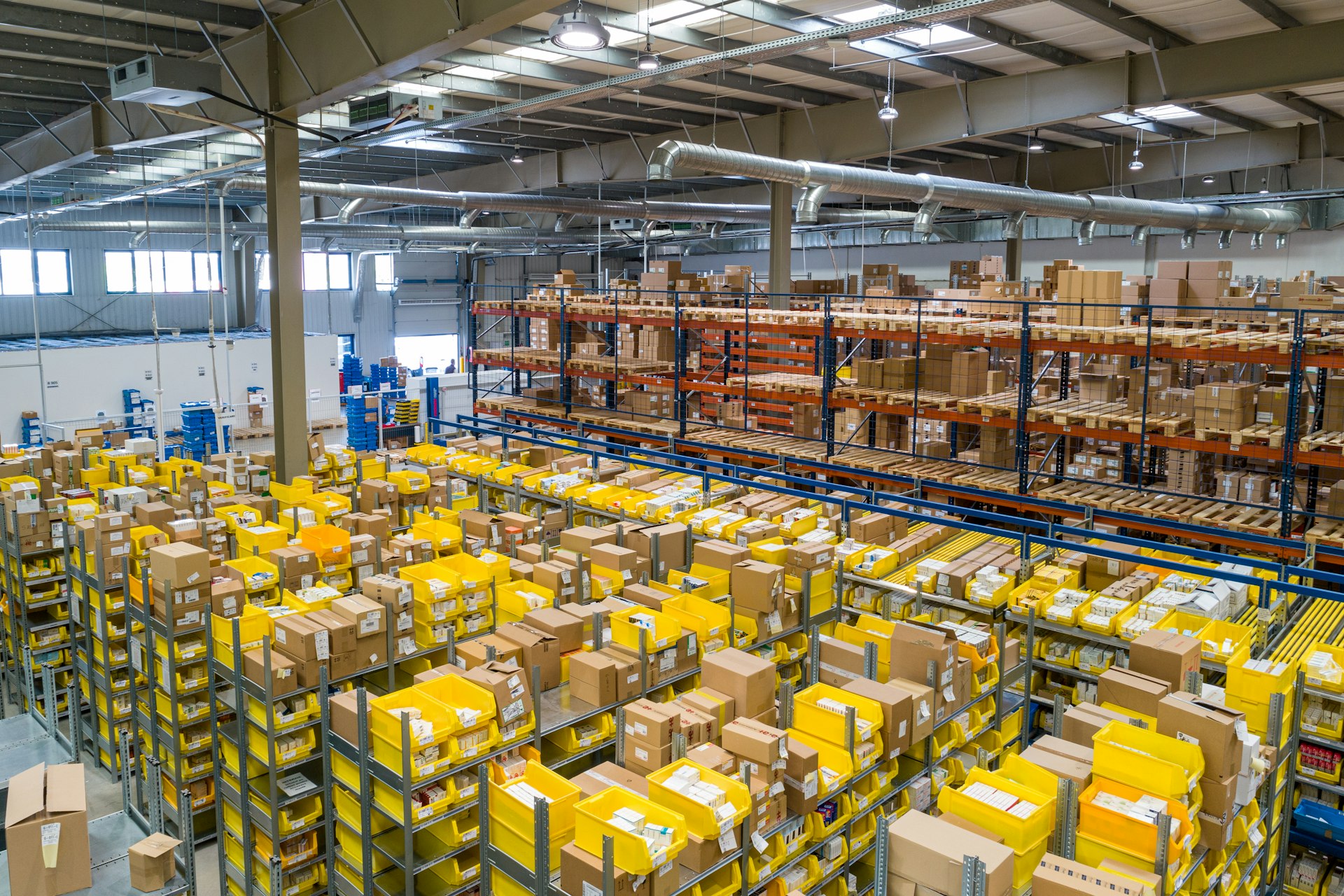 Elevated view of a large distribution warehouse with racking full of packaged inventory